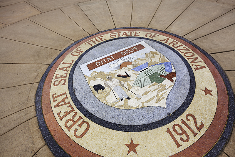 "The Great Seal of the state of Arizona in stone, outside the Arizona State Capitol in Phoenix."