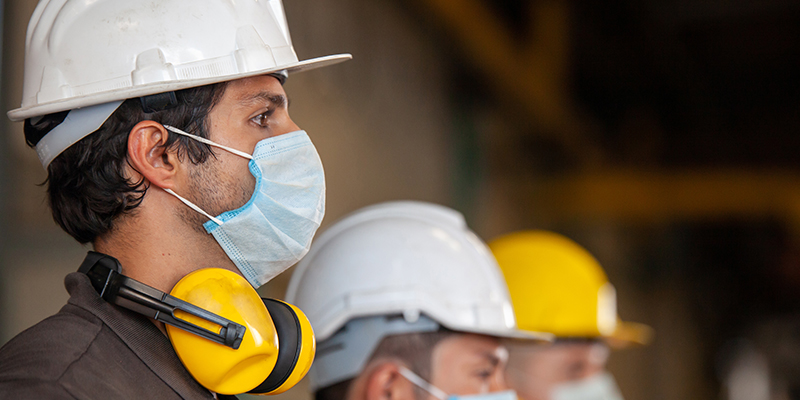 Workers wear protective face masks for safety